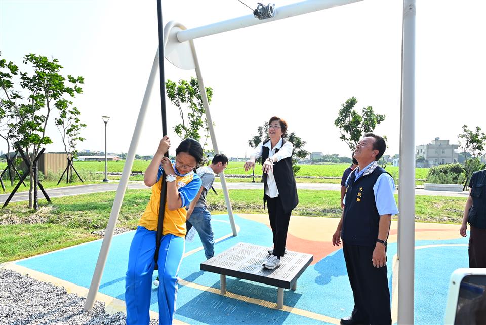 彰化縣長王惠美與大城鄉長陳玉照陪伴學童體驗大城追風公園「疾風飛行索」，感受滑行遊具的樂趣。（圖／彰化縣政府提供）